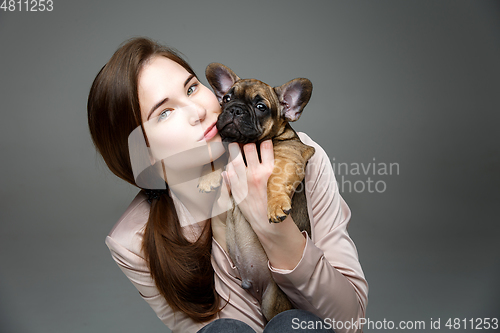 Image of girl with french bulldog puppy