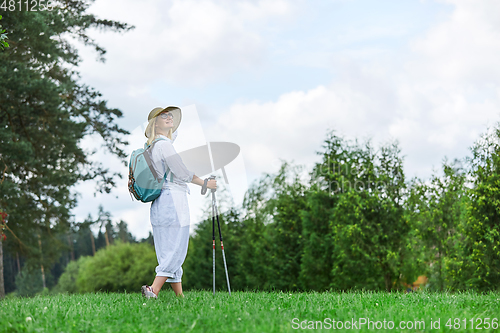 Image of young woman with nordic walk pols