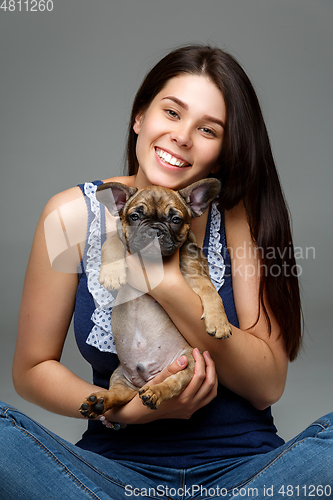 Image of girl with french bulldog puppy