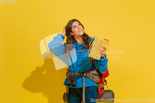 Image of Full length portrait of a cheerful young caucasian tourist girl isolated on yellow background