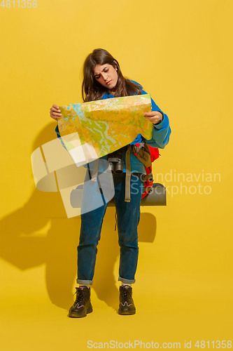 Image of Full length portrait of a cheerful young caucasian tourist girl isolated on yellow background