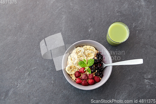 Image of cereal breakfast with berries, banana and spoon