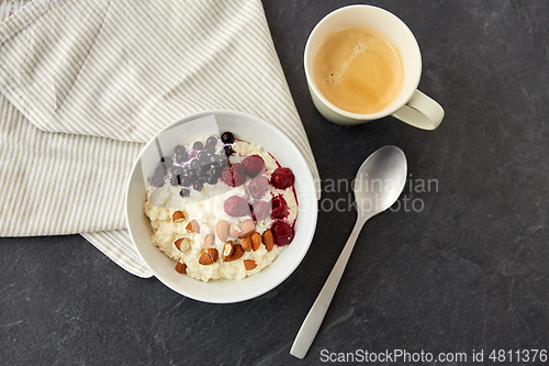 Image of porridge breakfast with berries, almonds and spoon