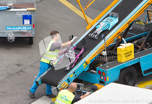 Image of AMSTERDAM, NETHERLANDS - JUNE 29, 2017: Loading luggage in airpl