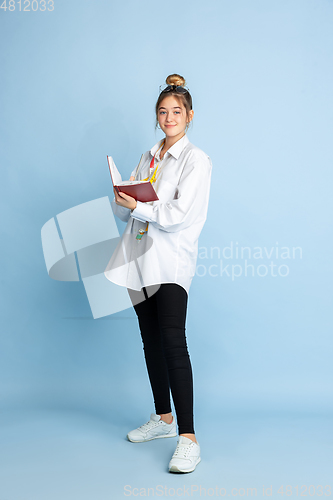 Image of Young girl dreaming about future profession of seamstress