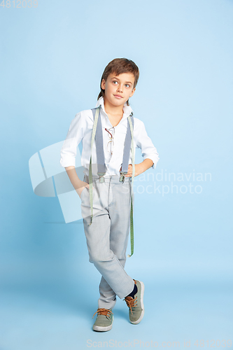 Image of Little boy dreaming about future profession of seamstress