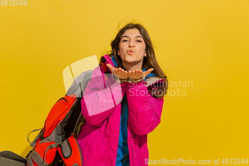 Image of Portrait of a cheerful young caucasian tourist girl isolated on yellow background