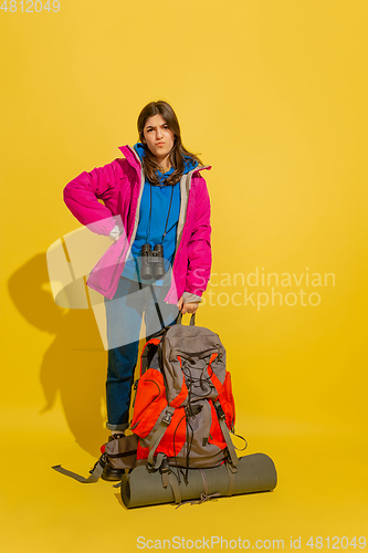 Image of Full length portrait of a cheerful young caucasian tourist girl isolated on yellow background