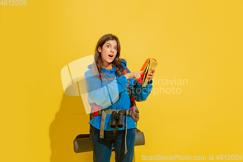 Image of Full length portrait of a cheerful young caucasian tourist girl isolated on yellow background