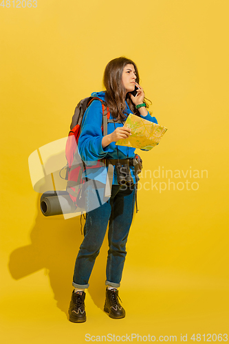 Image of Full length portrait of a cheerful young caucasian tourist girl isolated on yellow background