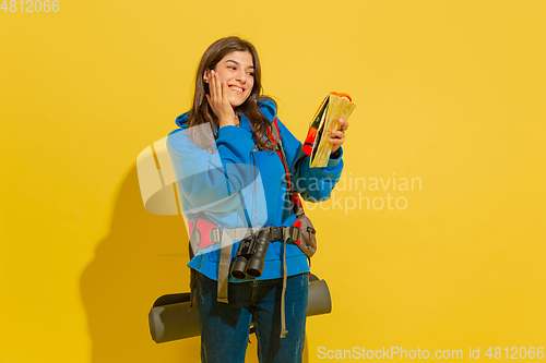 Image of Full length portrait of a cheerful young caucasian tourist girl isolated on yellow background