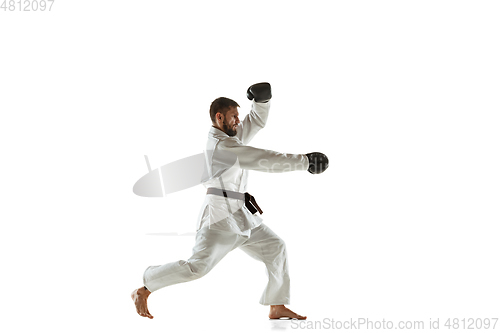 Image of Confident coach in kimono practicing hand-to-hand combat, martial arts