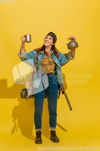 Image of Portrait of a cheerful young caucasian tourist girl isolated on yellow background