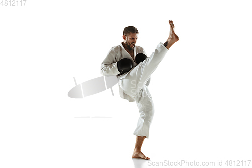 Image of Confident coach in kimono practicing hand-to-hand combat, martial arts