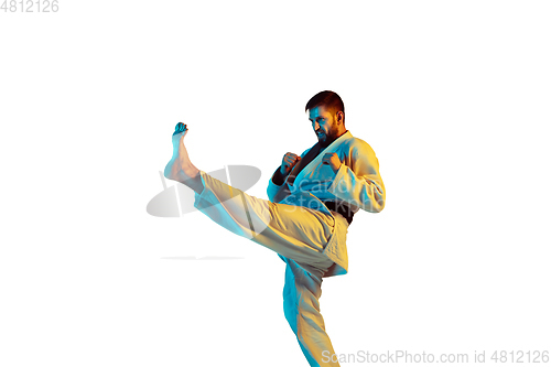 Image of Confident coach in kimono practicing hand-to-hand combat, martial arts