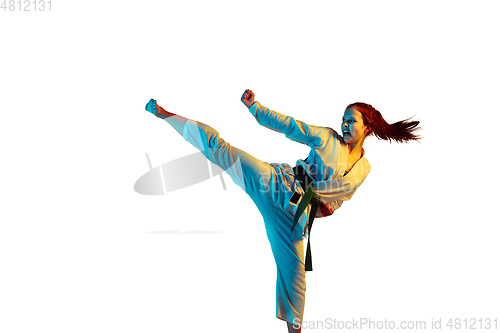 Image of Confident junior in kimono practicing hand-to-hand combat, martial arts