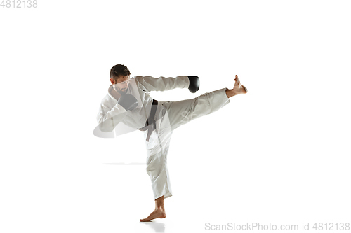 Image of Confident coach in kimono practicing hand-to-hand combat, martial arts