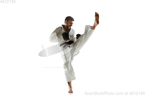 Image of Confident coach in kimono practicing hand-to-hand combat, martial arts