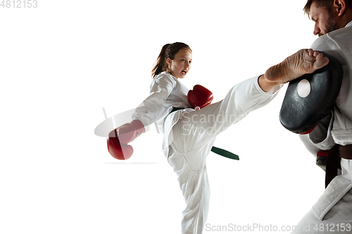 Image of Junior in kimono practicing hand-to-hand combat with coach, martial arts