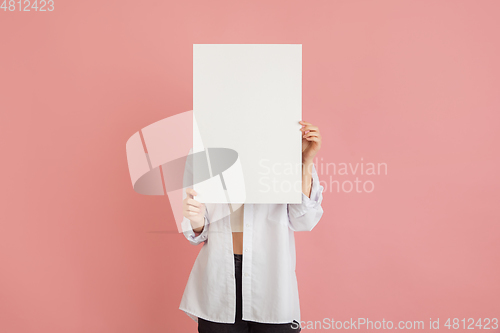 Image of Asian young woman\'s portrait on pink studio background. Concept of human emotions, facial expression, youth, sales, ad.