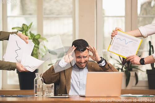 Image of Man working in modern office using devices and gadgets during creative meeting.