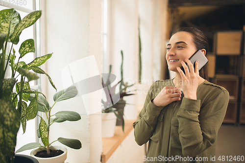 Image of Woman working in modern office using devices and gadgets during creative meeting.