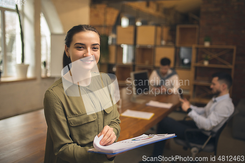 Image of Woman working in modern office using devices and gadgets during creative meeting.