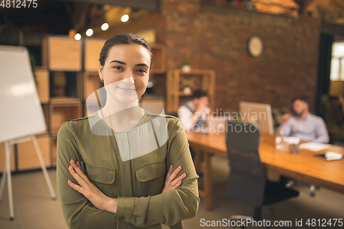 Image of Woman working in modern office using devices and gadgets during creative meeting.