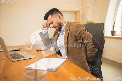 Image of Man working in modern office using devices and gadgets during creative meeting.