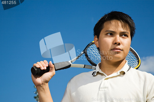 Image of Asian male playing tennis