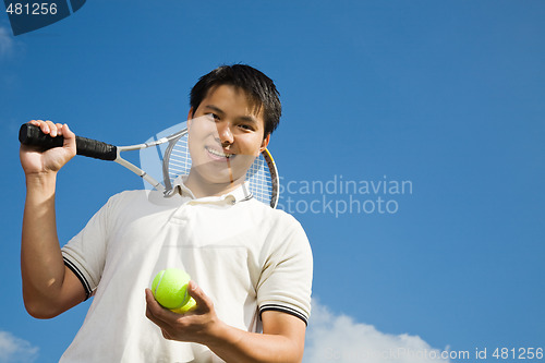 Image of Asian male playing tennis