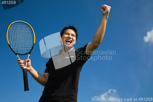 Image of Asian tennis player in joy of victory