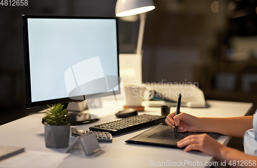 Image of designer with computer and pen tablet at office