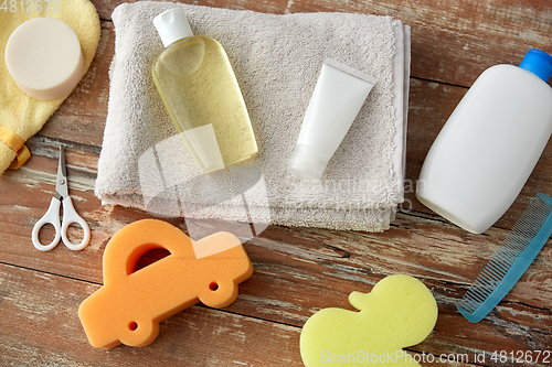 Image of baby accessories for bathing on wooden table