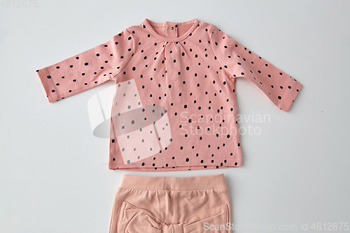 Image of pink shirt and pants for baby girl over white