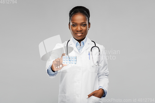 Image of african american female doctor with medicine pills