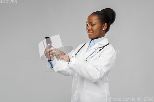 Image of african american female doctor with smartphone