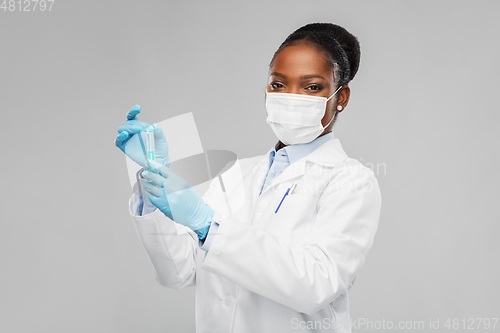 Image of african american female doctor with syringe