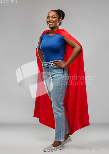 Image of happy african american woman in red superhero cape