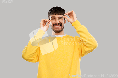 Image of goofy young man in glasses and yellow sweatshirt