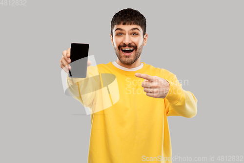 Image of happy smiling young man showing smartphone