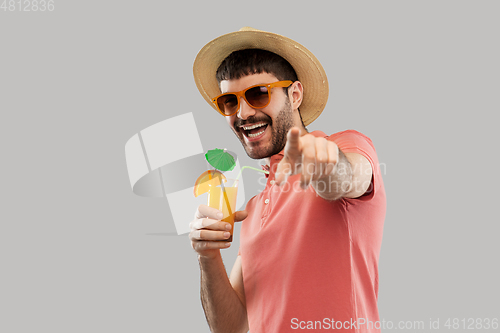 Image of happy man in straw hat with orange juice cocktail