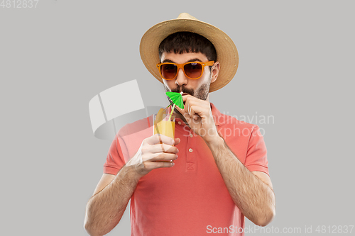 Image of happy man in straw hat with orange juice cocktail