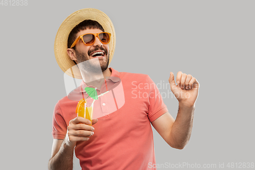 Image of happy man in straw hat with orange juice cocktail