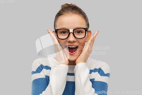 Image of surprised teenage student girl in taped glasses