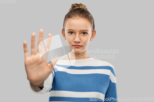 Image of teenage girl making stopping gesture