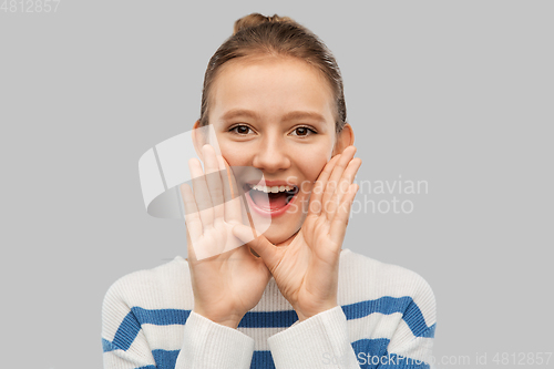 Image of happy teenage girl calling someone