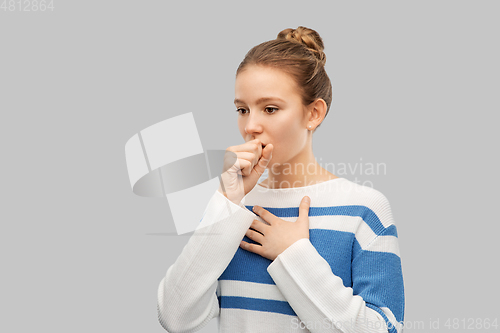 Image of sick coughing teenage girl in pullover