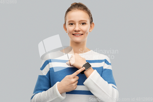 Image of happy smiling teenage girl with smart watch