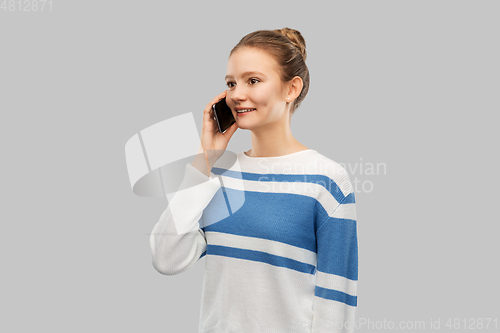 Image of happy smiling teenage girl calling on smartphone